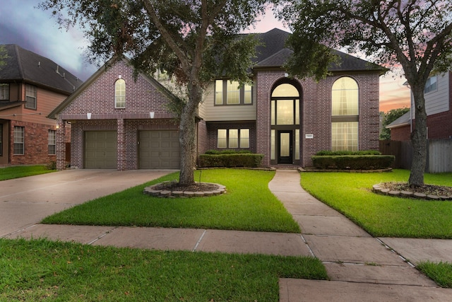 view of front of property featuring a garage and a yard