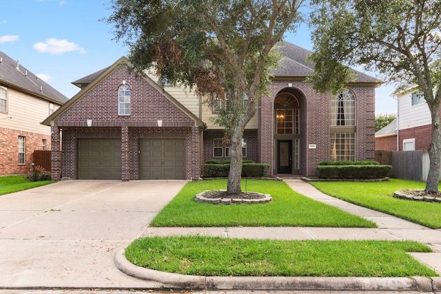 front facade featuring a garage and a front lawn