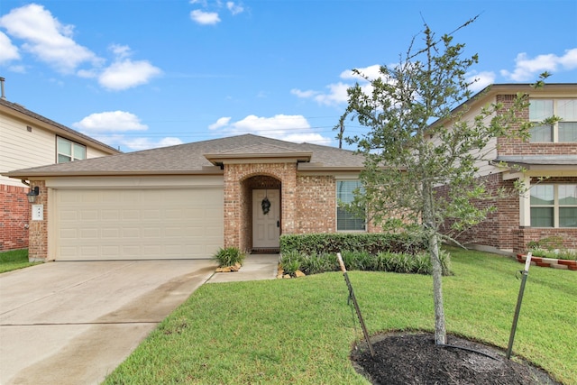 view of front of property featuring a garage and a front lawn