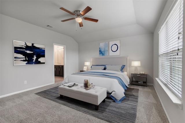 bedroom with lofted ceiling, connected bathroom, ceiling fan, and carpet flooring