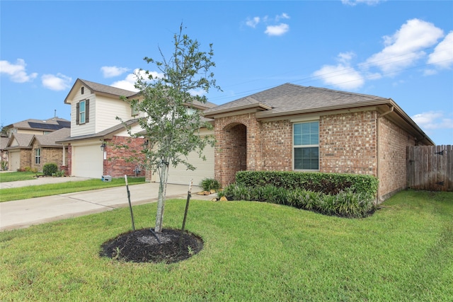 view of front of home with a garage and a front lawn