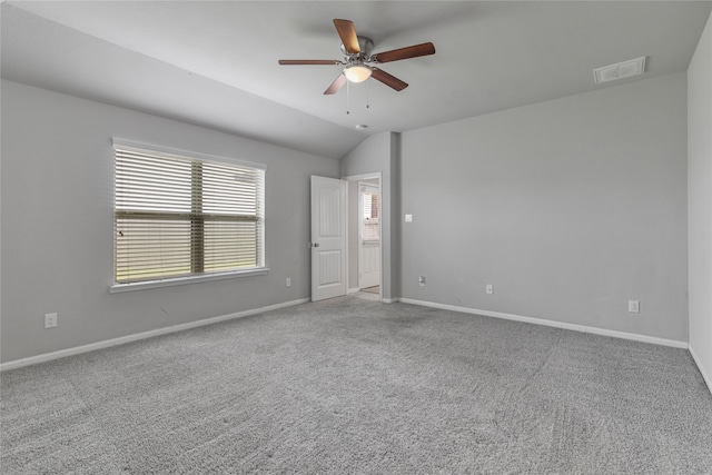 empty room featuring ceiling fan, light carpet, and vaulted ceiling