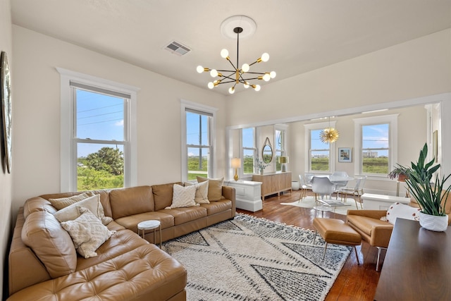 living room featuring an inviting chandelier and wood-type flooring