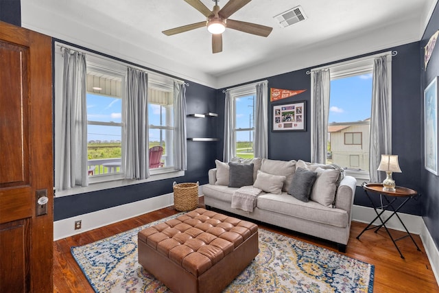 living room with a wealth of natural light, ceiling fan, and hardwood / wood-style floors