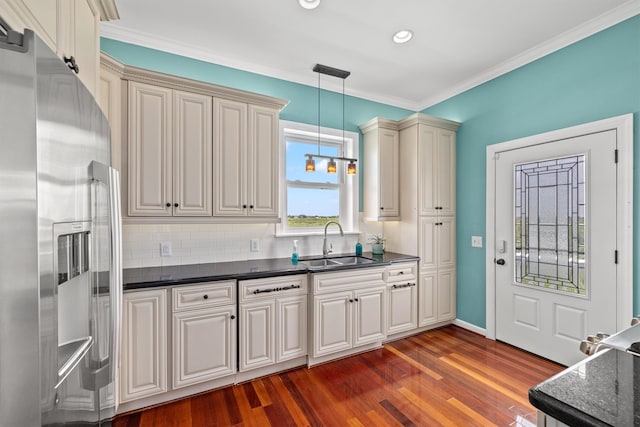 kitchen featuring dark hardwood / wood-style floors, decorative light fixtures, high end fridge, and backsplash