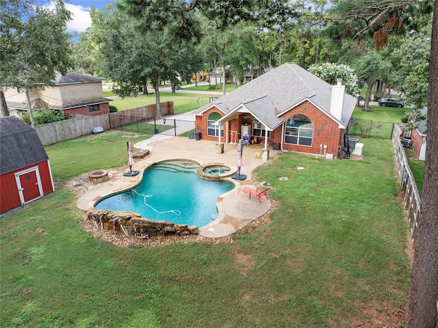 view of pool with a storage unit, a patio, and a yard