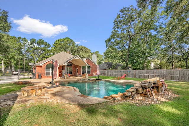 view of swimming pool featuring a patio and a lawn