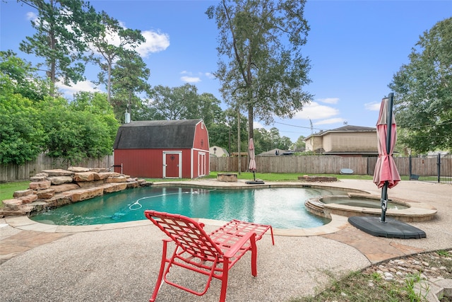 view of pool with a patio, a storage shed, and an in ground hot tub