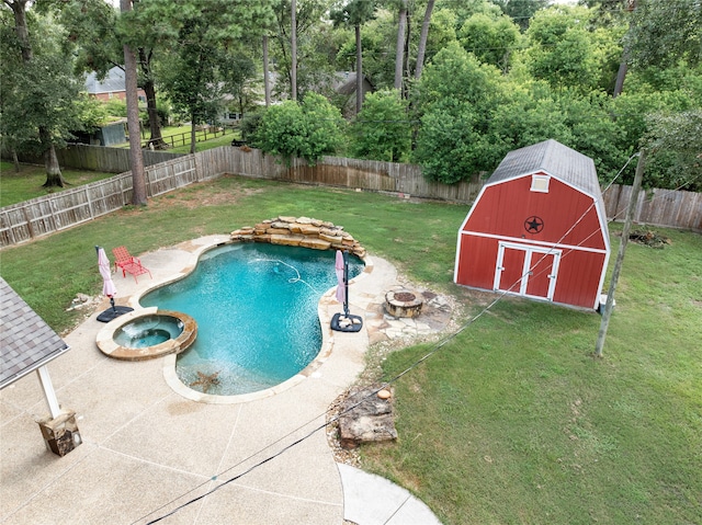 view of pool featuring a storage shed, an in ground hot tub, a patio area, and a lawn