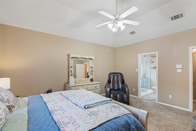 bedroom featuring light colored carpet, vaulted ceiling, ceiling fan, and ensuite bathroom