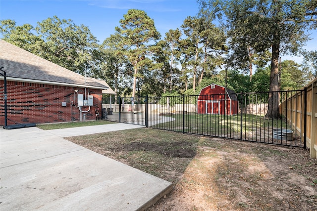 view of gate with a yard and a shed