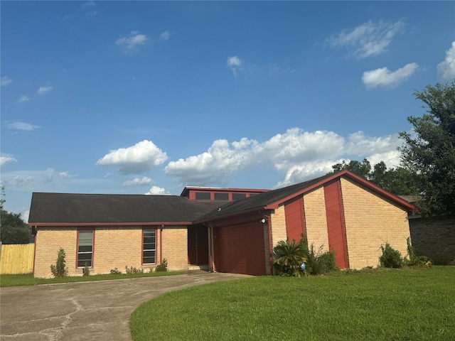 view of front of property with a garage and a front yard