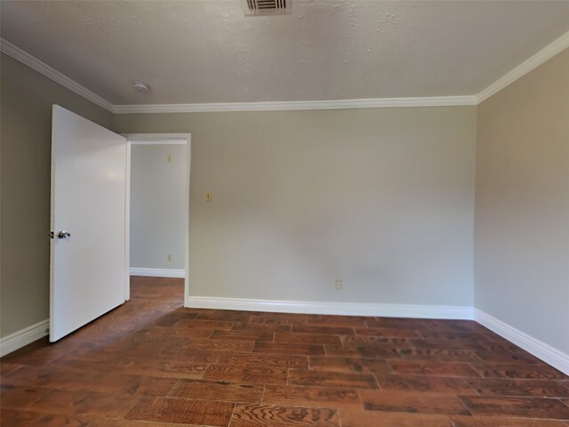 empty room with crown molding, dark wood-type flooring, and a textured ceiling