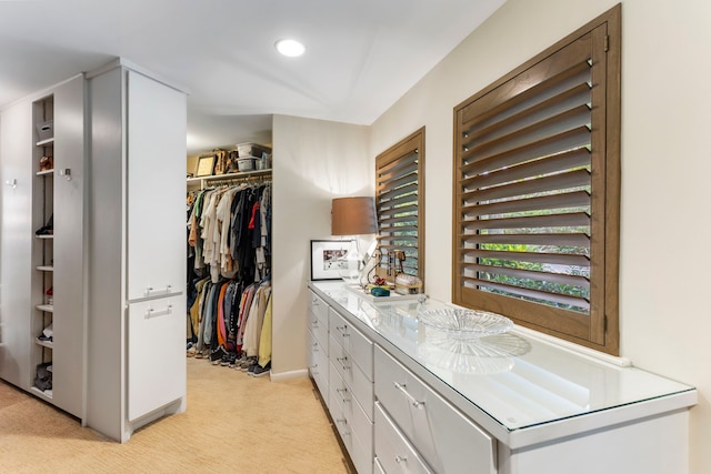 spacious closet featuring light carpet