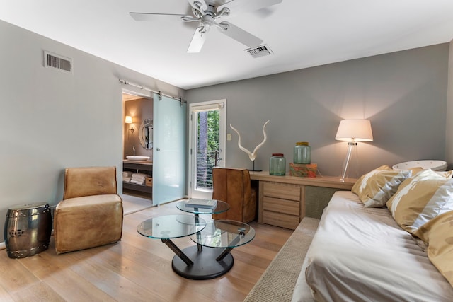 living room with ceiling fan and light wood-type flooring