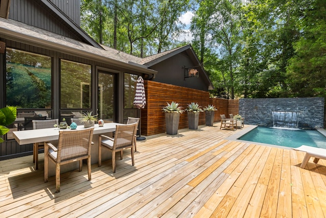 wooden terrace featuring pool water feature