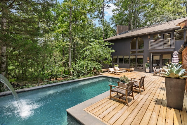 view of pool featuring a wooden deck and pool water feature