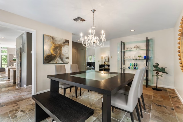 dining space featuring an inviting chandelier and tile patterned floors