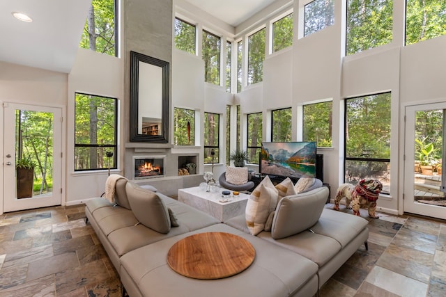 living room featuring tile patterned flooring and a towering ceiling