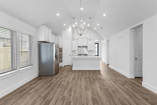 kitchen featuring light hardwood / wood-style floors, pendant lighting, a kitchen island, white cabinetry, and appliances with stainless steel finishes