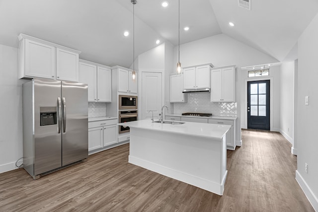 kitchen with appliances with stainless steel finishes, pendant lighting, sink, light hardwood / wood-style floors, and white cabinets