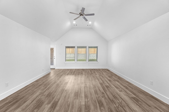 unfurnished living room with hardwood / wood-style flooring, ceiling fan, and lofted ceiling