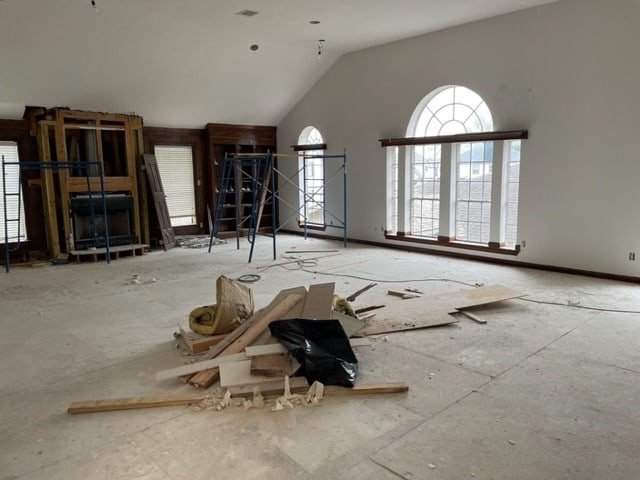 unfurnished living room featuring a healthy amount of sunlight and high vaulted ceiling