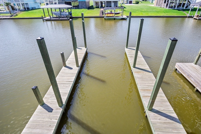 dock area with a water view and a lawn