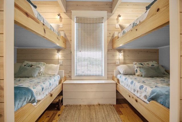 bedroom featuring wood walls and hardwood / wood-style floors