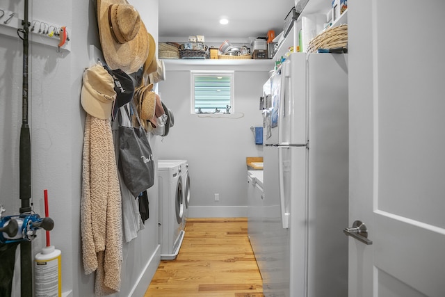 laundry area featuring light hardwood / wood-style flooring and separate washer and dryer