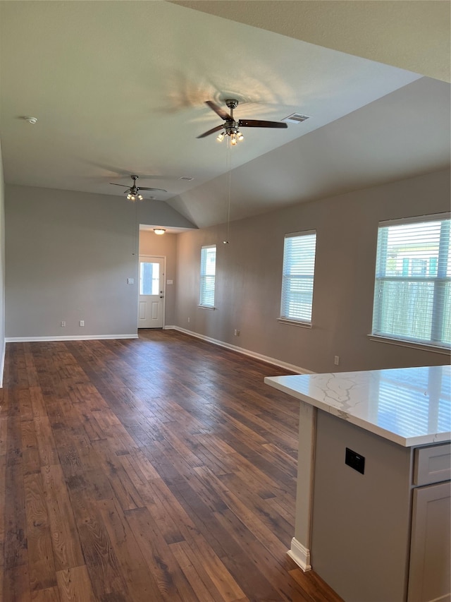 unfurnished living room featuring ceiling fan, dark wood-type flooring, and lofted ceiling