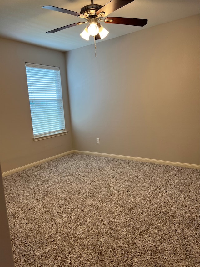 carpeted empty room featuring ceiling fan