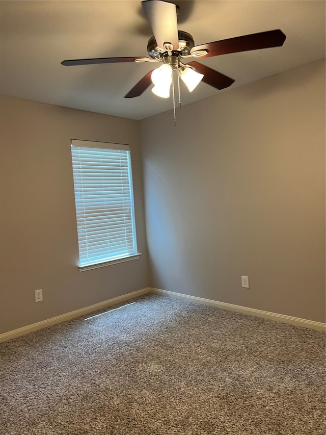 spare room with ceiling fan and carpet