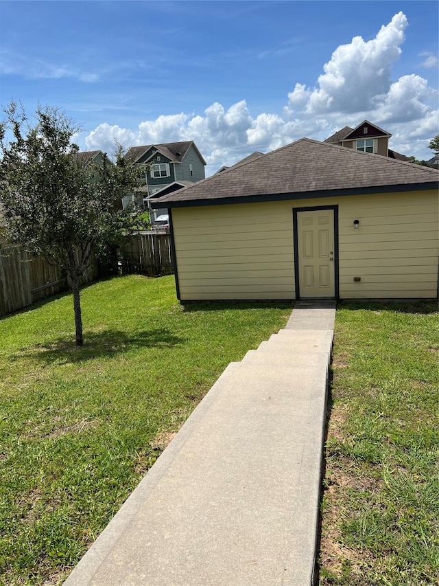 rear view of house featuring a yard