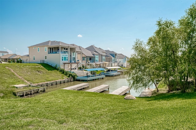 dock area with a water view and a lawn