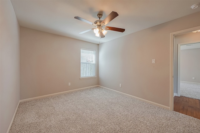 carpeted spare room featuring ceiling fan