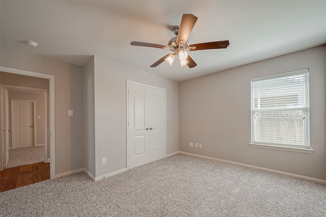 unfurnished bedroom featuring ceiling fan, carpet flooring, and a closet