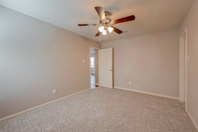 empty room featuring ceiling fan and carpet flooring