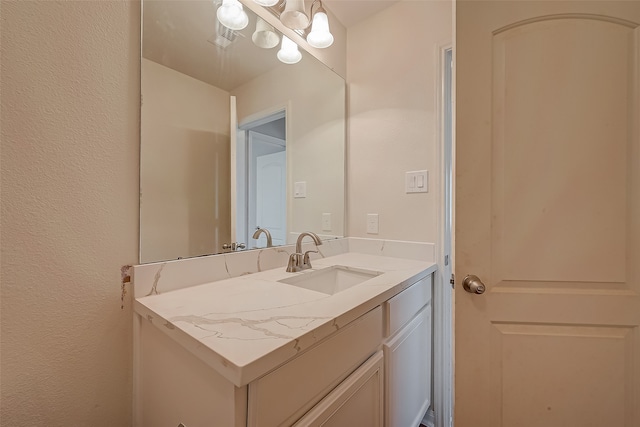 bathroom featuring vanity and a chandelier