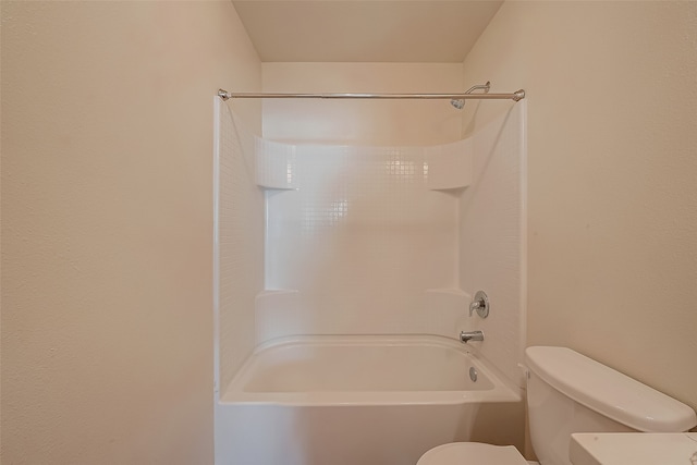 bathroom featuring shower / tub combination and toilet