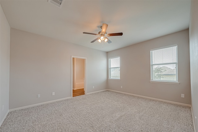 carpeted empty room featuring ceiling fan