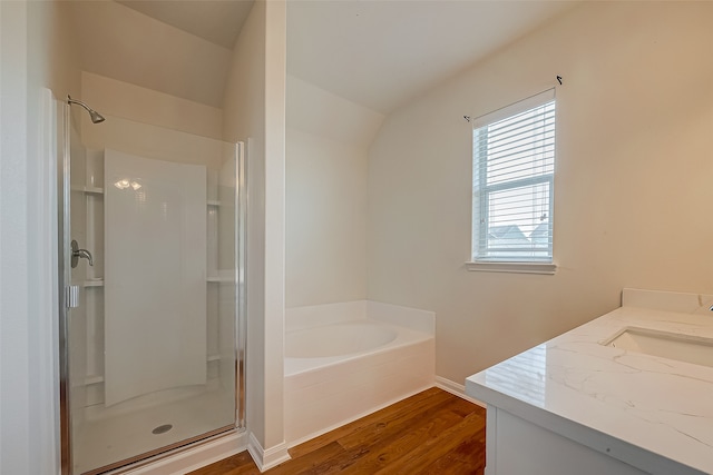 bathroom with plus walk in shower, vanity, and wood-type flooring