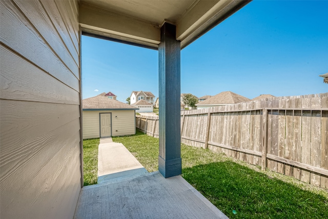 view of yard featuring a patio area and a shed