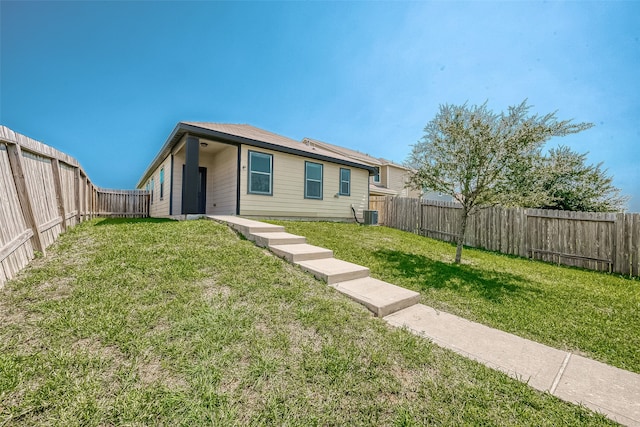 view of front of house featuring a front yard and central AC unit