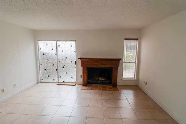 unfurnished living room featuring light tile patterned flooring and a textured ceiling