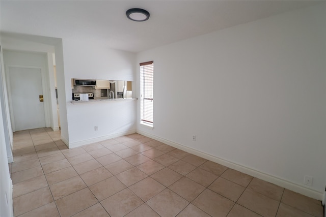 spare room with light tile patterned floors