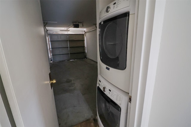 washroom featuring stacked washer / drying machine