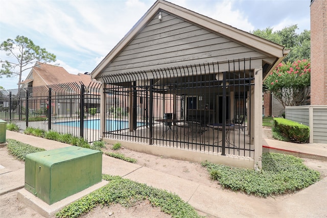 view of home's community with a swimming pool and a patio area