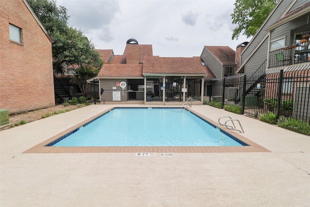 view of swimming pool featuring a patio area