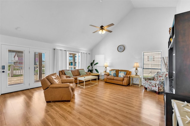 living room featuring ceiling fan, high vaulted ceiling, and light hardwood / wood-style floors